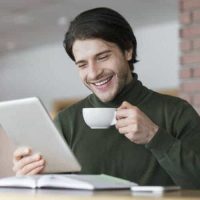young-successful-businessman-checking-emails-while-having-morning-coffee-e1631573561115.jpg
